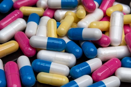 Tablets and pills on a black backgroundの写真素材