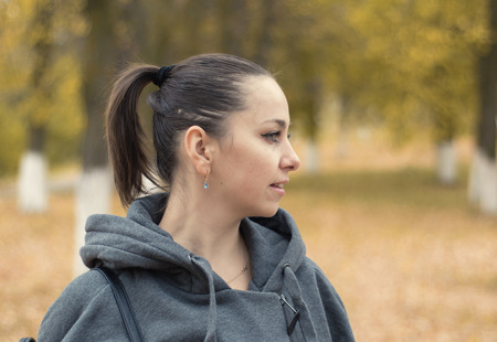 Beautiful girl on an autumn yellow background