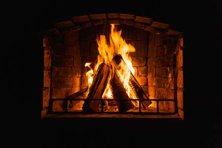 Glowing fire in home stone fireplace