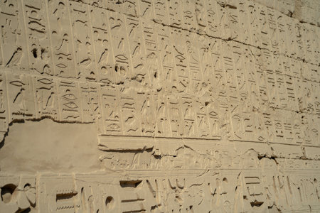 Ancient Egyptian ancient wall with carved hieroglyphs in Luxor