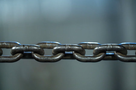Close-up of a metal chain on a blurred backgroundの写真素材