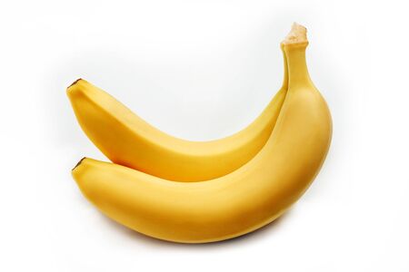Two bright yellow bananas on a white background.の写真素材