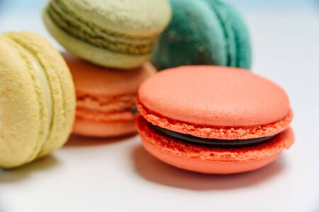 Bright multi-colored french macarons on a white background