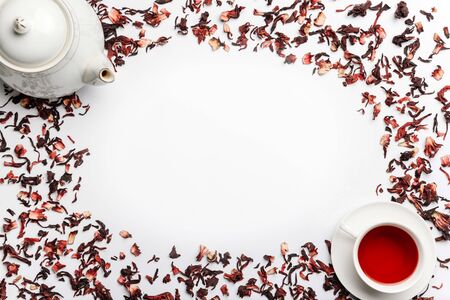 food frame from castings of hibiscus tea, teapot and cup with tea isolated on a white background with space for text.の写真素材