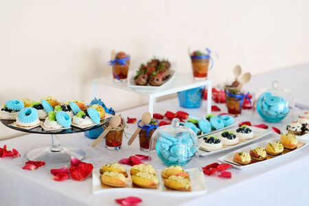 Festive candy bar with pastries and desserts in bright colors with selective focus.の写真素材