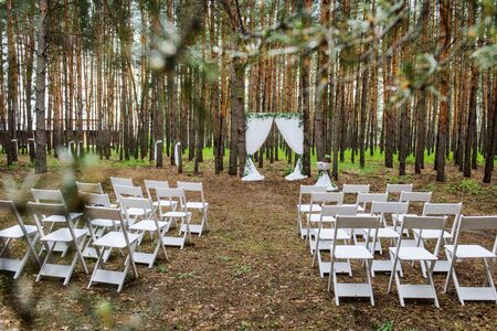 Decorated wedding venue in the forest. The concept of registration of marriage in nature.の写真素材