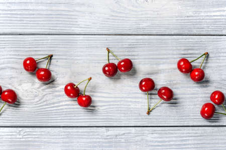 Ripe cherries on a background of light boards with a copy spaceの写真素材
