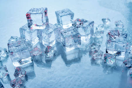 Chunks of ice for drinks on a blue background close-up.の写真素材