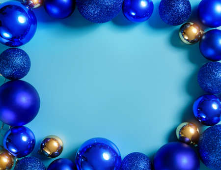 Composition with blue and gold Christmas balls on a blue background with copy space. Christmas frame.の写真素材