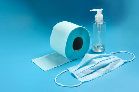 Medical mask, protective glove, toilet paper and sanitizer. Basic kit Covid 19.の写真素材