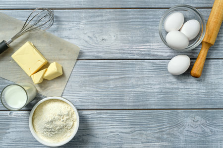 Food frame with ingredients for baking on the background of a light wooden table with copy space.の写真素材