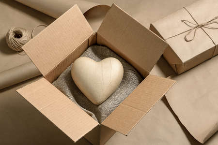 Close-up of a cardboard box with a paper heart inside. Valentine's Day gift concept.の写真素材