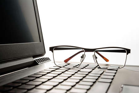 glasses lie on the laptop keyboard.