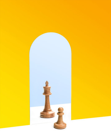 Chess pawn in front of the reflection of the chess queen in the mirror. Career growth concept.の写真素材