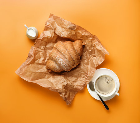 coffee and croissants on a yellow background.の写真素材