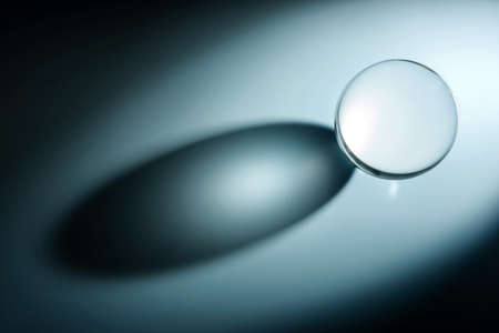 Composition with glass ball and shadow. Transparent ball with selective focus.の写真素材