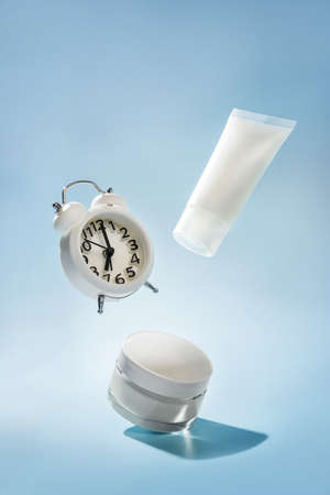 Levitating cosmetics and watches on a blue backgroundの写真素材