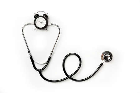 Stethoscope and alarm clock isolated on white background.の写真素材