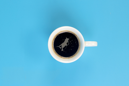 coffee cup on a light blue backgroundの写真素材