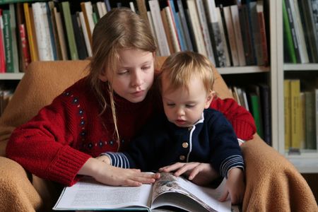 Young girl reading to a の写真素材