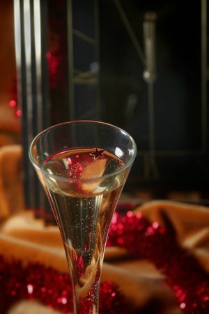 Glass of champagne on a golden-orange backgroundの写真素材