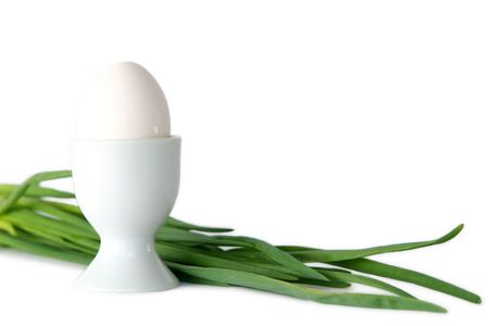 White egg in a cup  on a white backgroundの写真素材