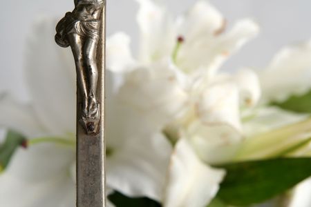 Old cross on white easter lilies backgroundの写真素材