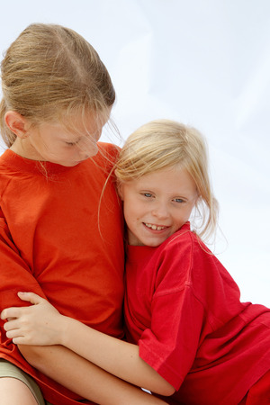 Portrait of young girls wearing red t-shirtsの写真素材