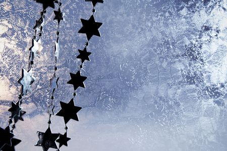Stars chain on a frozen glass backgroundの写真素材