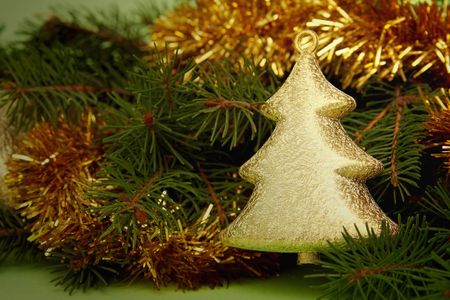 Golden decorations and spruce on a green backgroundの写真素材