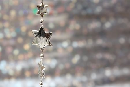 Silver stars chain on a glittering backgroundの写真素材