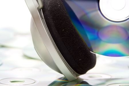 Grey and black earphones and compact disc