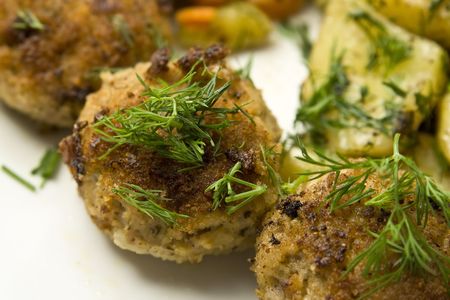 Pork burgers with potatoes, carrot and green peasの写真素材