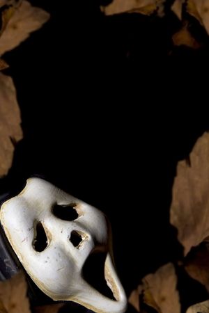 Pumpkins, autumnal leaves ad ghosts on a blackの写真素材