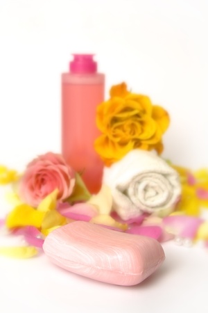Cosmetics with pink and yellow roses and petalsの写真素材