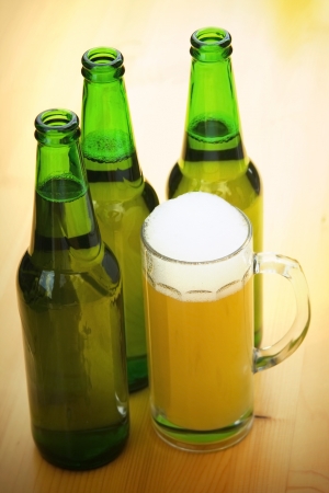 A mug of beer on wooden tableの写真素材
