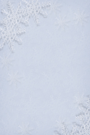 Blue and white snowflakes on a blue and white backgroundの写真素材
