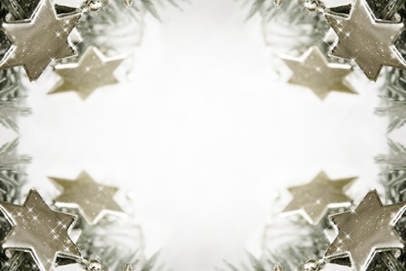 Silver sparkling stars on a white glistening backgroundの写真素材