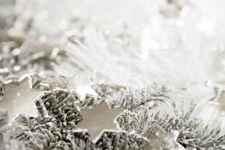 Silver sparkling stars on a white glistening backgroundの写真素材