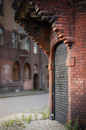 The entrance to the old red brick building is bricked up with black bricks.の写真素材