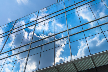 Clouds reflected in windows of modern office building