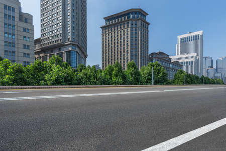 cityscape and skyline of shanghai from empty asphalt road