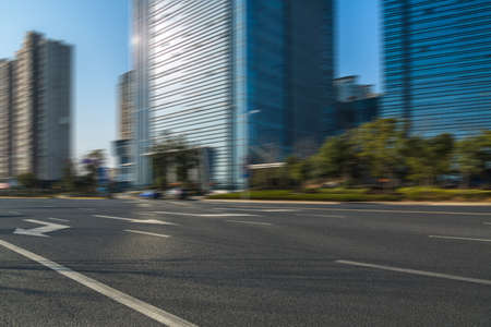 empty asphalt road front of modern buildingsの写真素材