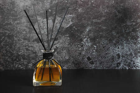 luxury design aroma reed diffuser glass bottle display on the black table in the bedroom