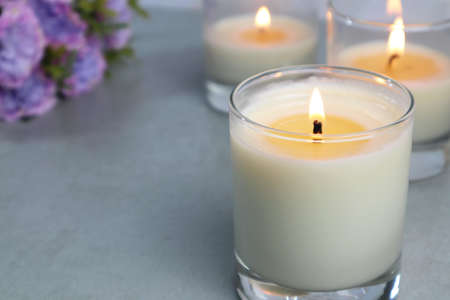 The luxury lighting aromatic scent glass candle diplay on the grey table in the white bedroom with background of the marble wall in the Christmas party with familyの写真素材