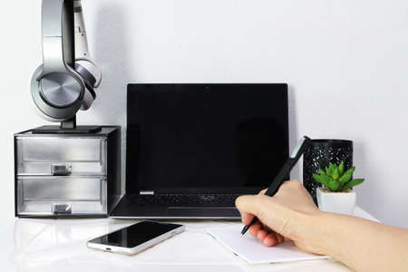 The personal computer, mobile phone, headphone are used for working from home during self quarantine to avoid the corona virus or covid 19の写真素材