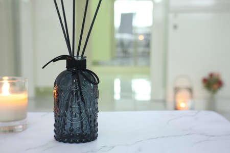 luxury aromatic scent of reed diffuser glass bottle is used as room freshener on the marble table...