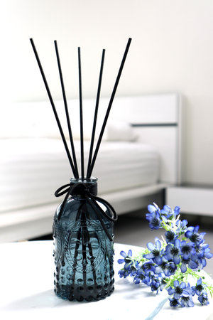 luxury aromatic scent of reed diffuser glass bottle is used as room freshener on the marble table in...