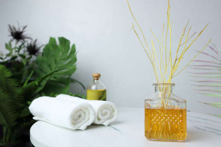 luxury aromatic scent of reed diffuser glass bottle is used as room freshener on the marble table...