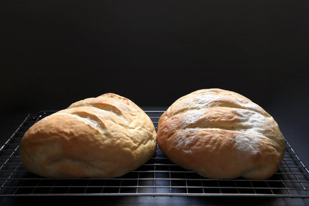 delicious homemade butter bread is on wooden black table with black cement wall backgound of the...